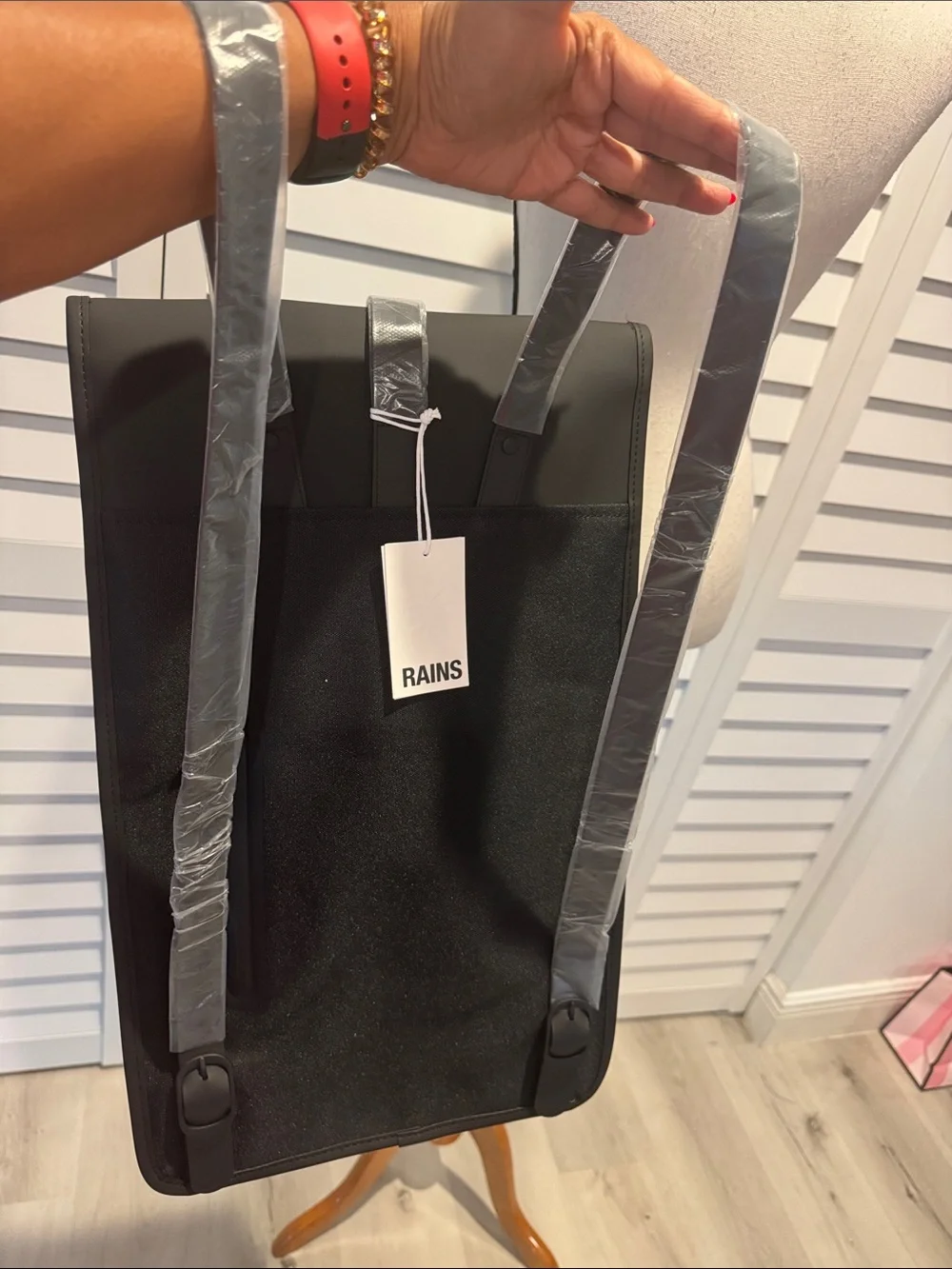 Rains NWT Black Matte Backpack, W/external Back phone pocket, fits a 15” laptop.